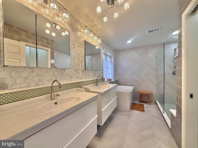 full bathroom with tile walls, visible vents, a shower stall, and a sink