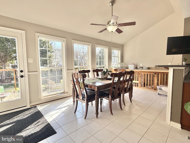 dining space with vaulted ceiling, light tile patterned floors, and ceiling fan