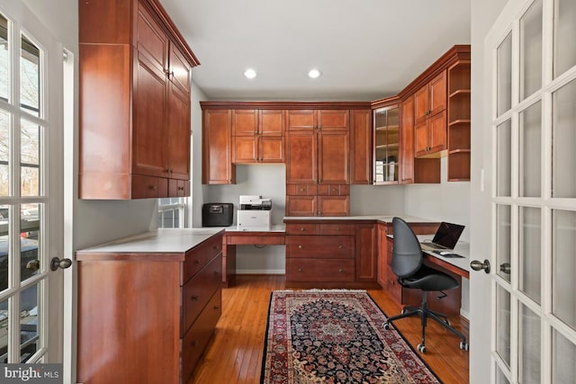 office featuring recessed lighting, light wood-style flooring, french doors, and built in study area