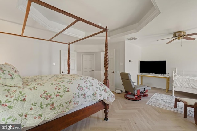 bedroom with visible vents and a tray ceiling