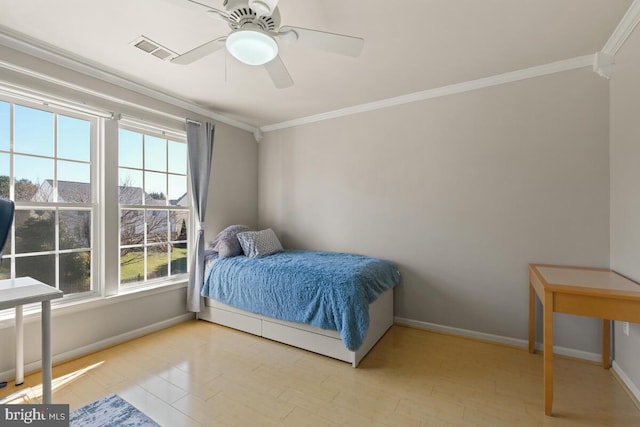 bedroom featuring visible vents, crown molding, baseboards, wood finished floors, and a ceiling fan