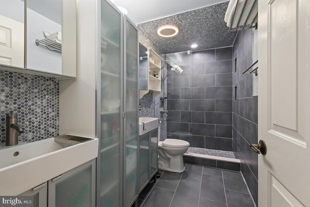 full bathroom with tile patterned flooring, a shower stall, toilet, and vanity