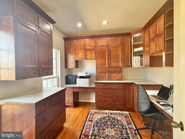 kitchen featuring built in desk, recessed lighting, light countertops, and light wood-style floors