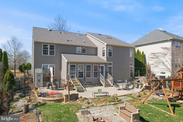 rear view of property with a fenced backyard, entry steps, a patio, and roof with shingles