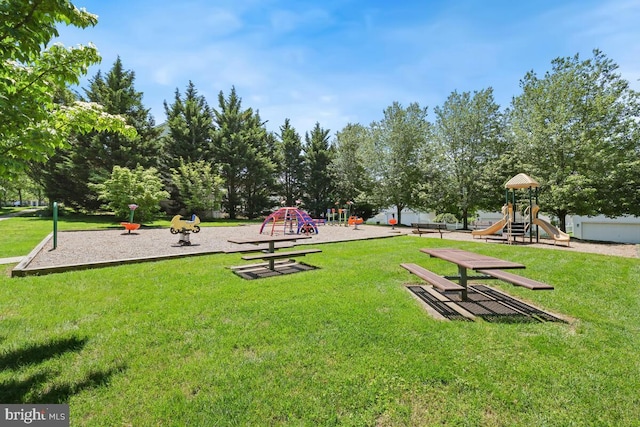 view of home's community featuring playground community and a lawn