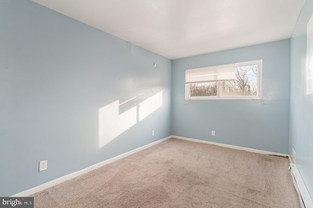 carpeted spare room featuring baseboards and baseboard heating