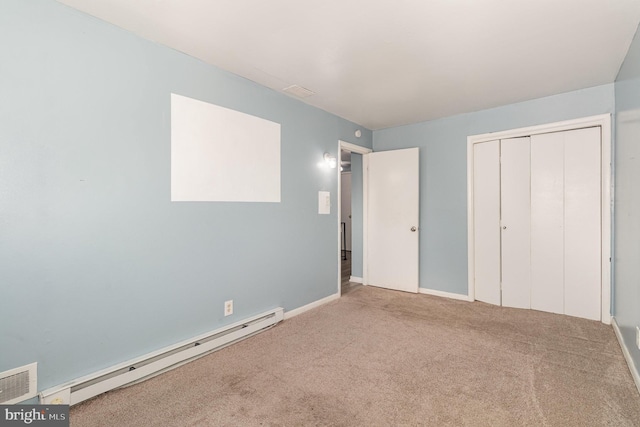 unfurnished bedroom with visible vents, baseboards, carpet floors, a closet, and a baseboard radiator