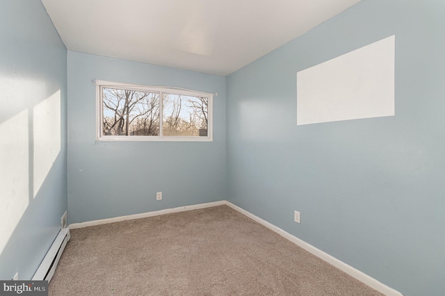 empty room with baseboard heating, baseboards, and carpet floors