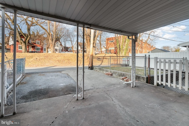 view of patio / terrace with a gate, a residential view, and fence