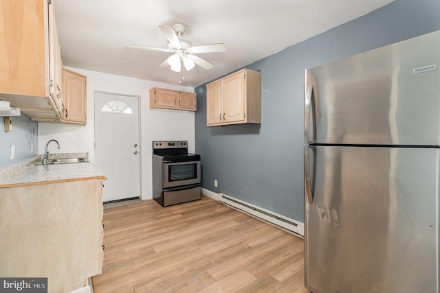 kitchen featuring light wood-style flooring, light brown cabinets, a sink, stainless steel appliances, and baseboard heating