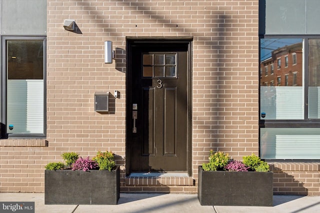 property entrance with brick siding