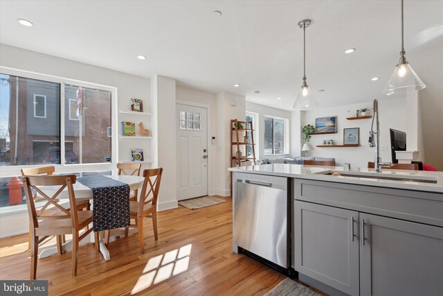 kitchen with light wood-type flooring, gray cabinetry, recessed lighting, dishwasher, and hanging light fixtures