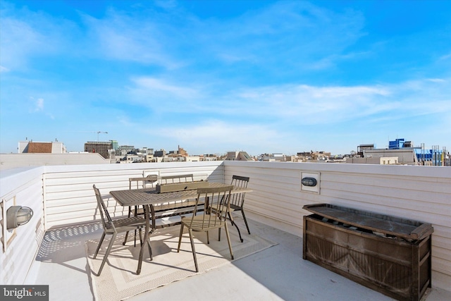 view of patio / terrace featuring a view of city and outdoor dining area