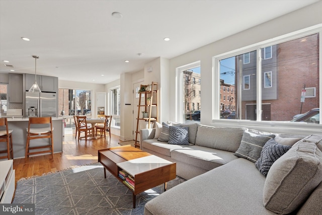 living room with recessed lighting and dark wood-style flooring