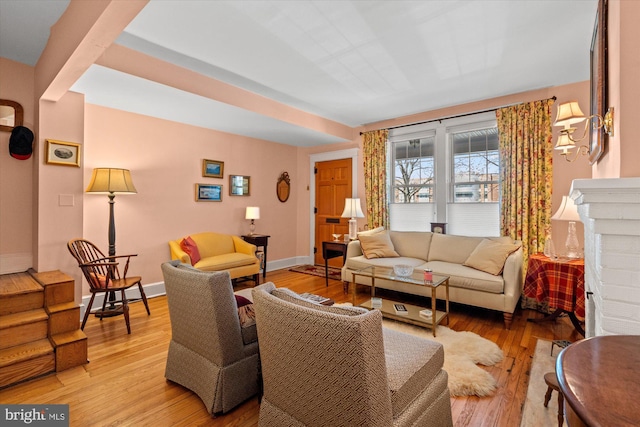 living area featuring baseboards and light wood-style floors