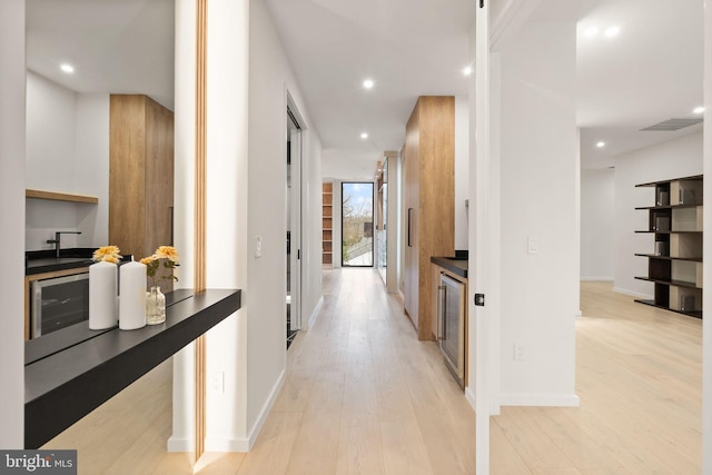 corridor with recessed lighting, visible vents, baseboards, and light wood-style flooring