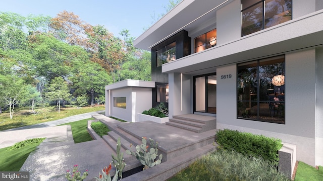 entrance to property featuring stucco siding