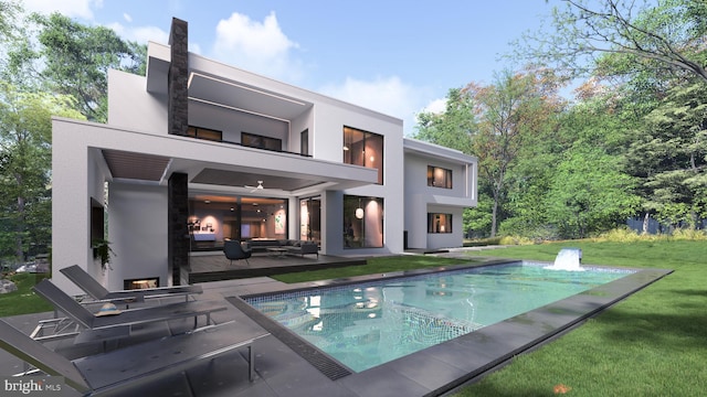 rear view of house with stucco siding, a lawn, a balcony, a patio area, and an outdoor pool