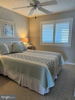 bedroom featuring baseboards, a textured ceiling, a ceiling fan, and carpet floors