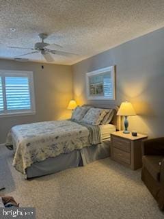 carpeted bedroom featuring a ceiling fan and a textured ceiling