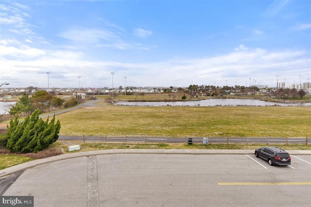 view of road featuring curbs and a water view