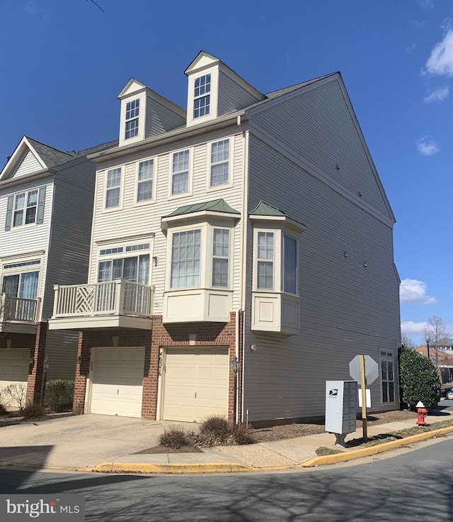 multi unit property featuring a garage, brick siding, and driveway