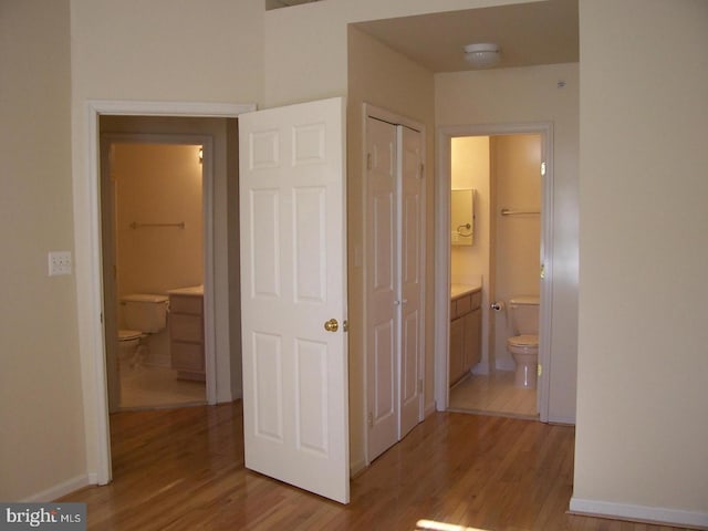 hall featuring baseboards and wood finished floors