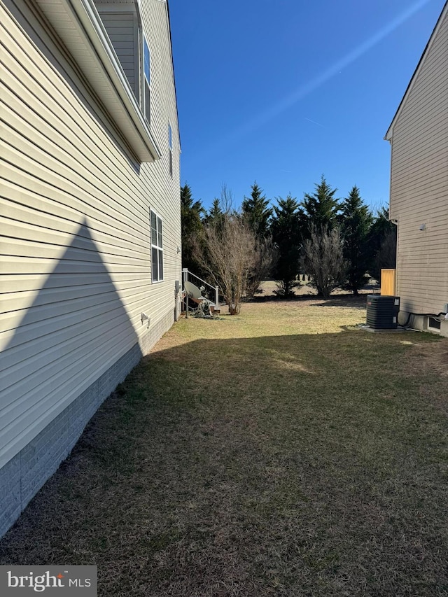 view of yard with central air condition unit