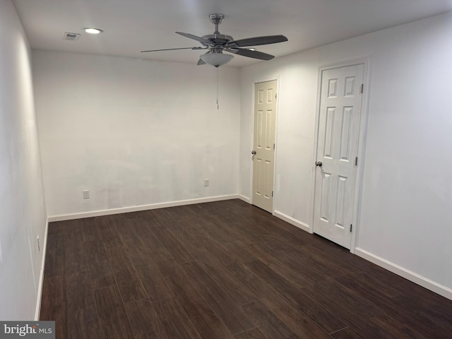 empty room featuring visible vents, dark wood-type flooring, a ceiling fan, recessed lighting, and baseboards