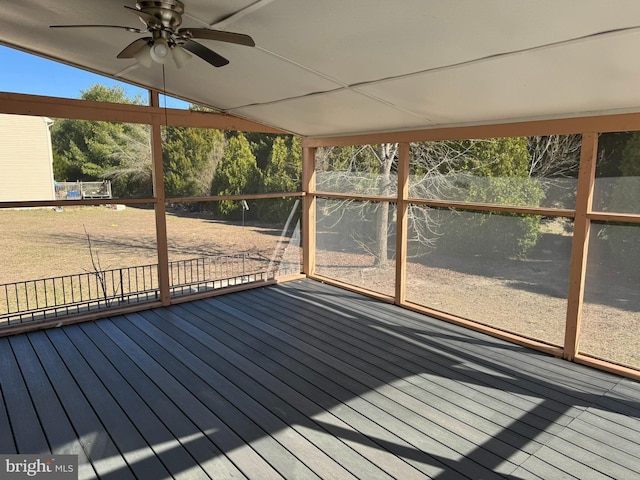 unfurnished sunroom with ceiling fan and vaulted ceiling