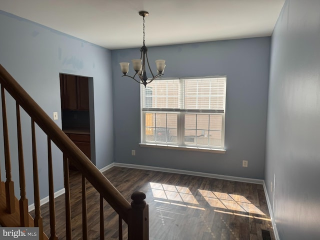 interior space with a chandelier, stairway, dark wood-type flooring, and baseboards