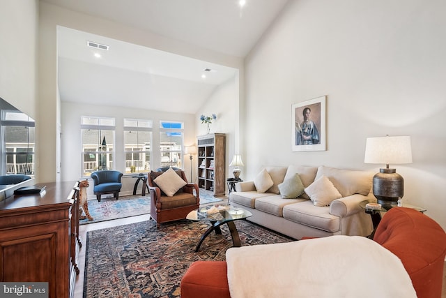 living room with visible vents and high vaulted ceiling