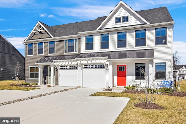 multi unit property featuring a standing seam roof, a shingled roof, concrete driveway, a garage, and metal roof