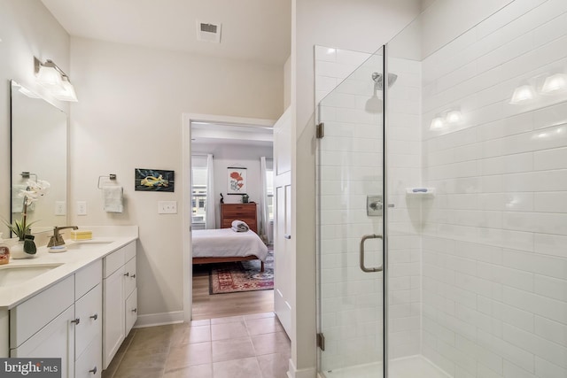 full bath with a sink, a stall shower, ensuite bath, and tile patterned floors