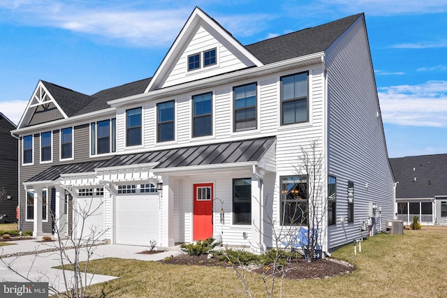 multi unit property featuring concrete driveway, a front yard, cooling unit, an attached garage, and a standing seam roof