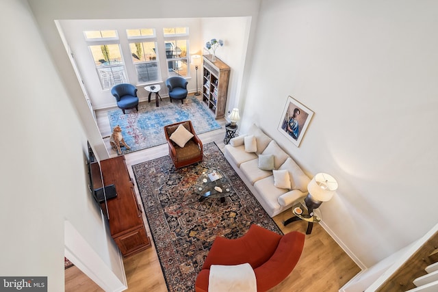 living room with baseboards and wood finished floors