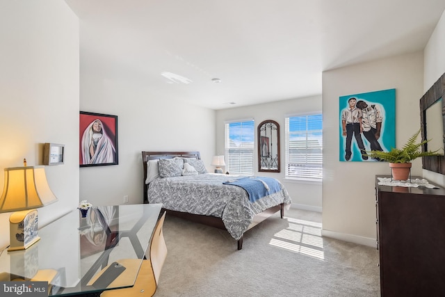 bedroom with baseboards and carpet floors