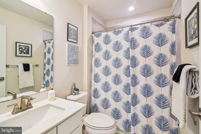 bathroom featuring toilet and vanity