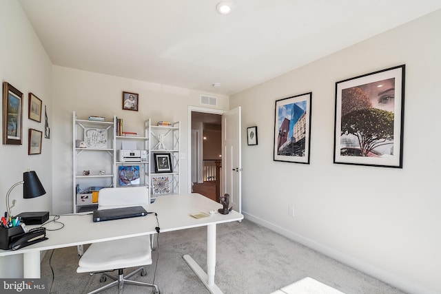 carpeted home office featuring visible vents and baseboards