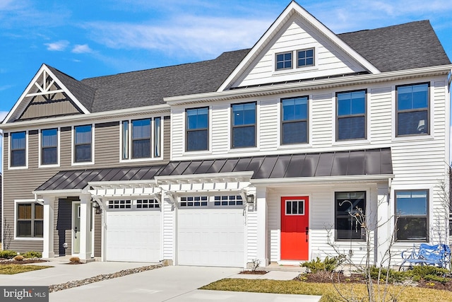 view of property with driveway, a standing seam roof, metal roof, a shingled roof, and a garage