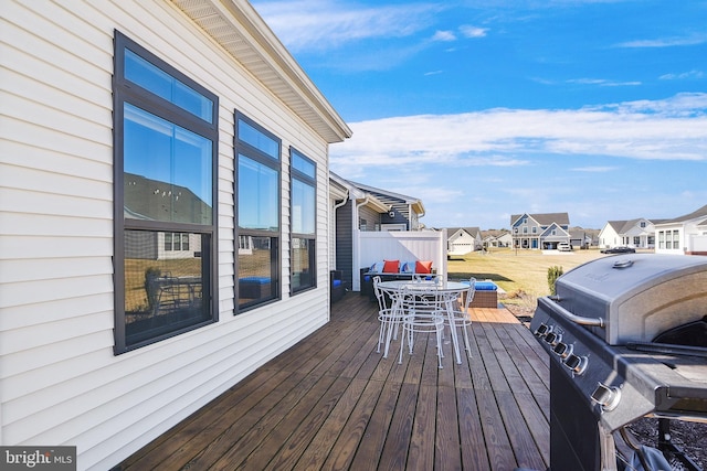 wooden deck with grilling area and a residential view