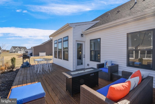 wooden terrace with an outdoor hangout area and outdoor dining area