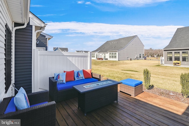 wooden deck featuring a lawn and an outdoor fire pit