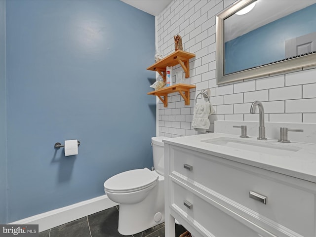 half bathroom with backsplash, baseboards, toilet, tile patterned floors, and vanity