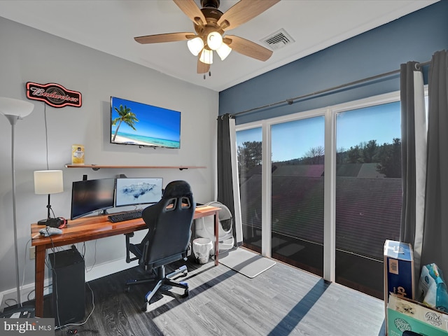 office area with ceiling fan, visible vents, baseboards, and wood finished floors