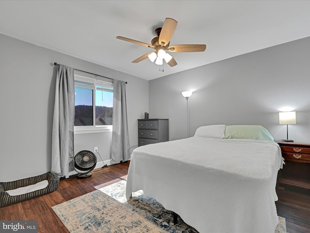 bedroom with baseboards, ceiling fan, and wood finished floors