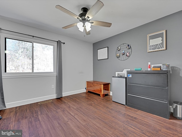 miscellaneous room with visible vents, a ceiling fan, baseboards, and wood finished floors