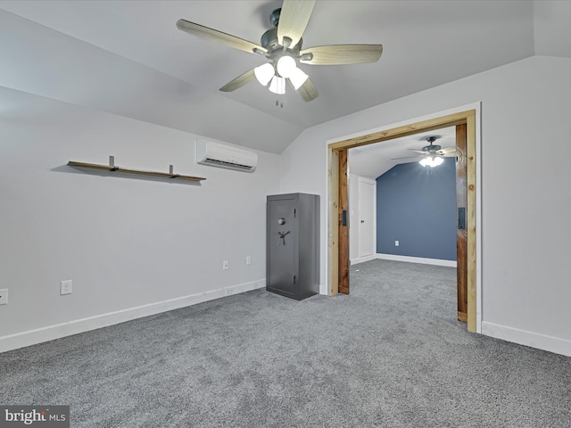 interior space featuring a wall unit AC, baseboards, carpet floors, and vaulted ceiling