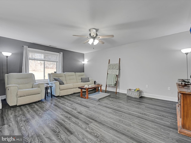 living room featuring a ceiling fan, baseboards, and wood finished floors