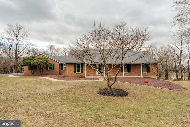 ranch-style home with a front yard and brick siding